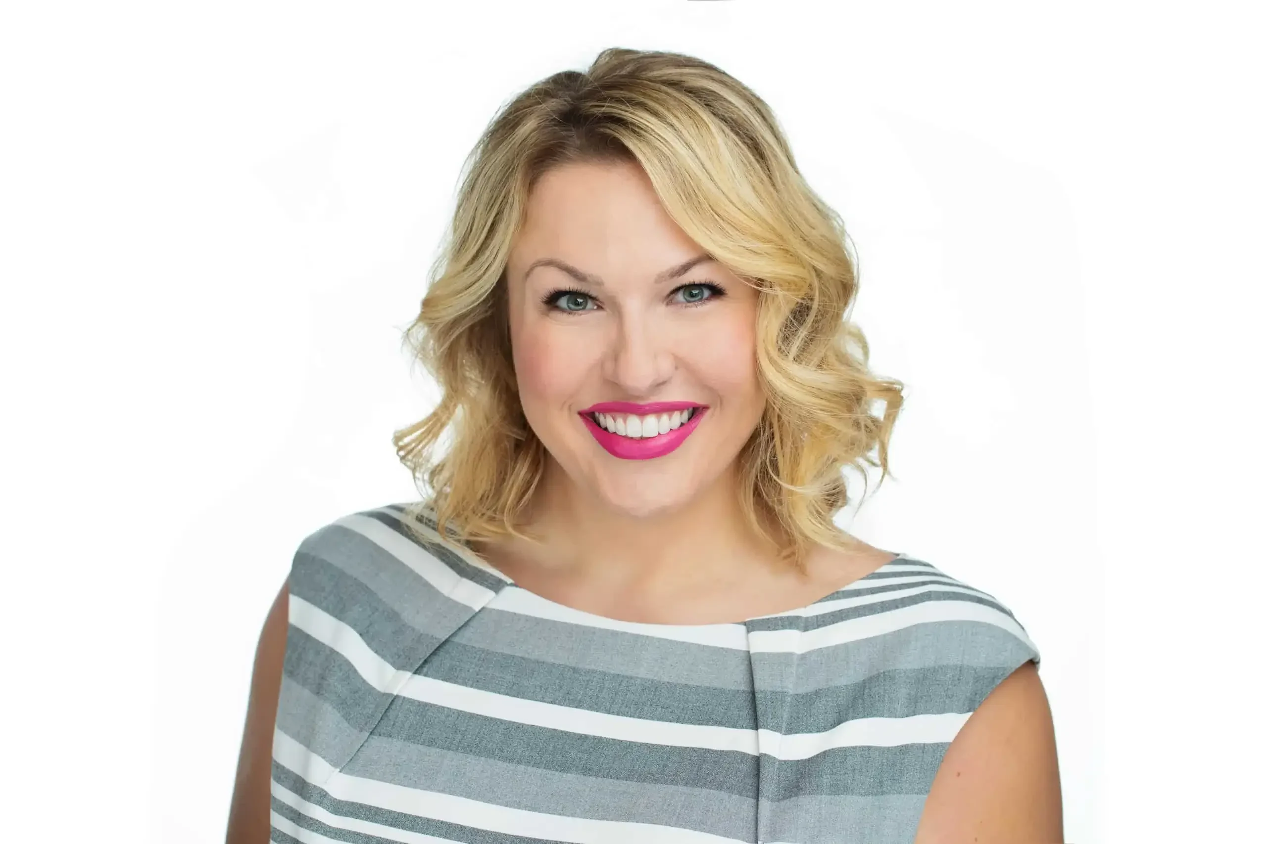 Woman with shoulder-length blonde hair wearing a sleeveless gray and white striped top against a white background.